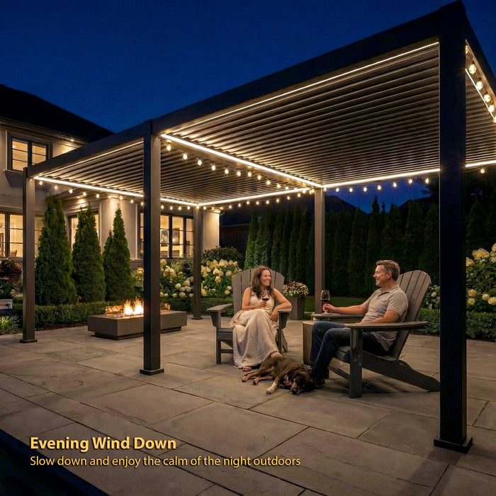 Couple relaxing under a black pergola with string lights on a patio at night.
