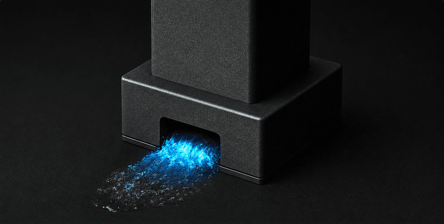 Water flowing from the base of a square metal post.