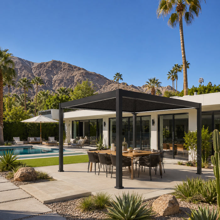 Black modern pergola covering an outdoor dining set on a desert patio with palm trees, a swimming pool, and rocky mountains in the background.